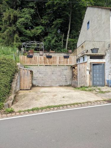 an old house with a door on the side of the road at 4 persons wohnung in de Eifel in Baustert