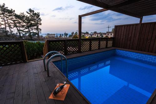 a swimming pool on the deck of a house at White dream Pension in Jeju