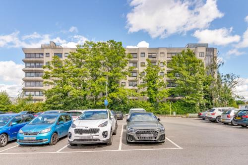 a group of cars parked in a parking lot at Modern Living Stevenage 2bed Apartment Town Centre up to 8 people Tesco at Doorstep in Stevenage