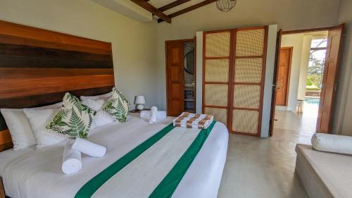 a bedroom with a large bed with a wooden headboard at Misty Villa by DBI in Pussellawa