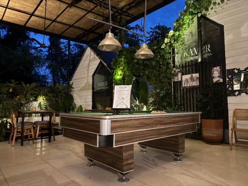 a ping pong table in the middle of a patio at The Jungle Hostel Canggu in Canggu
