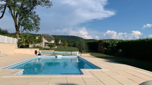 a swimming pool in the middle of a yard at La perle des Lacs in Dompierre-sur-Mont