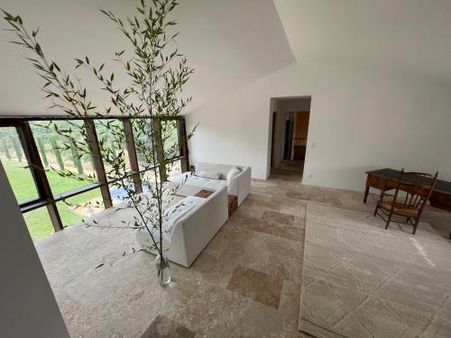 a living room with a white couch and a table at Bastide du Luberon in Apt