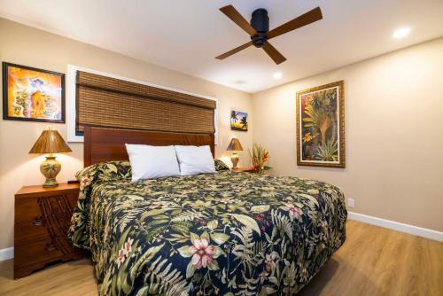 a bedroom with a bed and a ceiling fan at Kihei Beach Resort 608 in Kihei