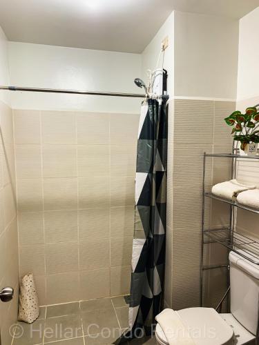 a bathroom with a shower and a toilet at HELLAR Condo Rentals in Bacolod