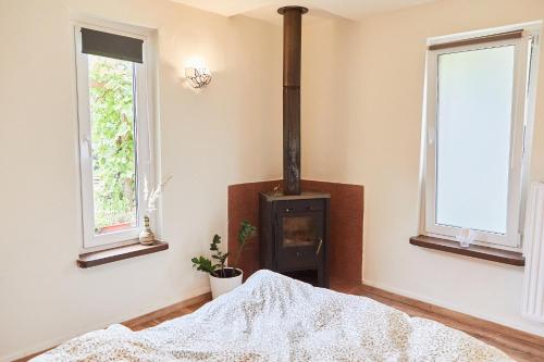 a bedroom with a wood stove in a room at Guesthouse with 3 apartments, just outside Berlin, near to Tesla in Burig