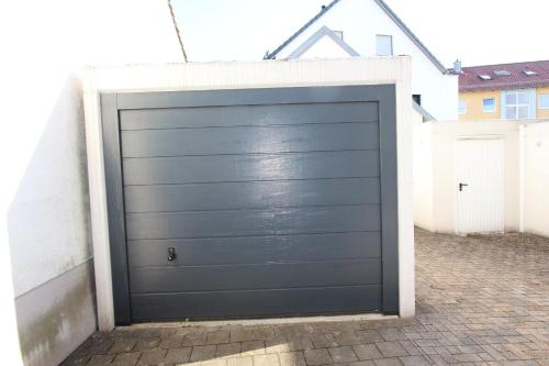 a black garage door in a parking lot at Ferienwohnung Petra in Neumarkt in der Oberpfalz
