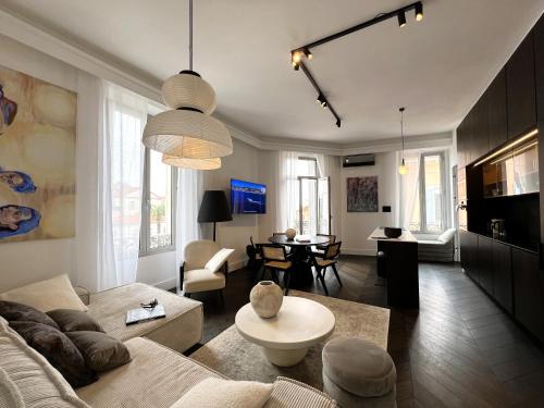 a living room with a couch and a table at Luxury Cannes in Cannes