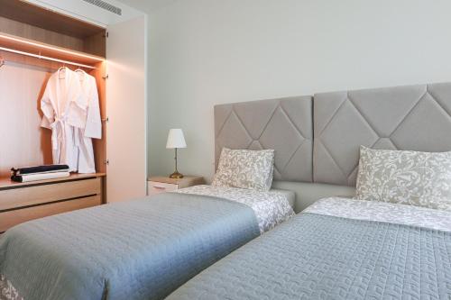 Ένα ή περισσότερα κρεβάτια σε δωμάτιο στο Cond Bayline - Breeze Wellness & Living - Bacalhau - BY BEDZY