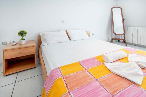 a bedroom with a bed and a dresser and a chair at Kos Center Katerina in Kos Town
