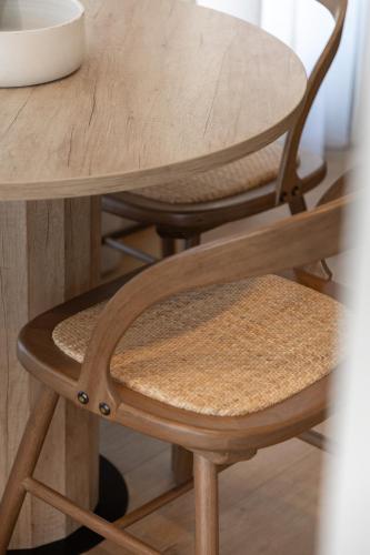 a wooden table with a wooden chair and a wooden stool at Rebalance Apartments in Athens