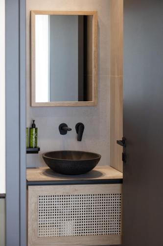 a bathroom with a sink and a mirror at Rebalance Apartments in Athens