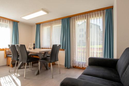 a living room with a table and chairs and a couch at Abendstern in Saas-Almagell
