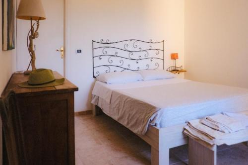 a bedroom with a bed and a table with a hat on it at Blu di Prussia in Laureana Cilento