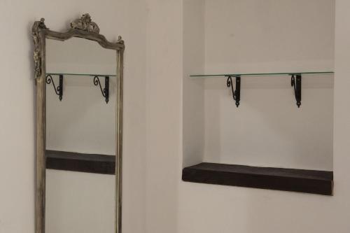 a mirror and a shelf in a room at Al borgo maison in Oliveto Citra
