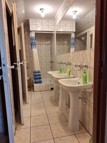 a bathroom with two sinks and two toilets at Folwark in Stronie Śląskie