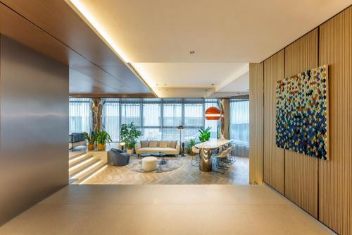 a living room with a couch and a table at Holiday Inn Express Shanghai Jing'an Temple by IHG in Shanghai