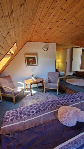 a bedroom with a large bed and a table and chairs at Penzion a restaurant Sportturia in Polesí