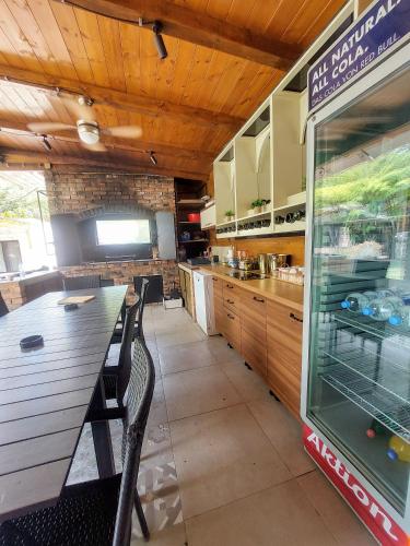 a kitchen with a long table in a restaurant at Vila MP Banstol 4*- Brdež do, Fruška gora in Inđija