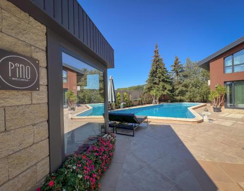 a hotel with a swimming pool and a building at Pino - Villa, Casa, Cucina е Terrazza in Albena