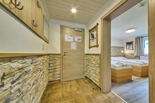 a room with two beds and a hallway at Ski & Bike Appartements Forsthaus in Saalbach Hinterglemm