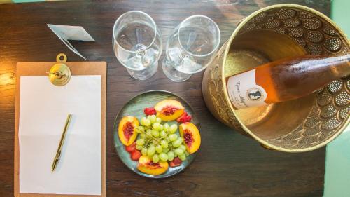 a table with a bottle of beer and a plate of fruit at Juan Rodriguez Hacienda in Athens