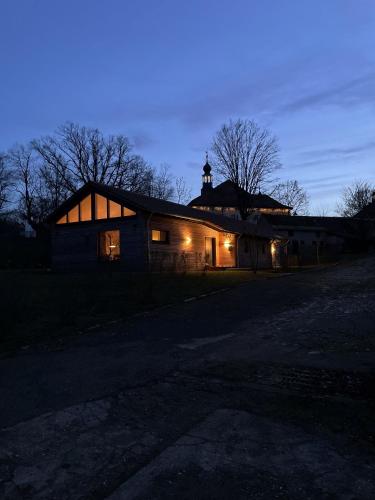 a barn lit up at night with lights on it at Gästewohnung am Schlosspark Hohenprießnitz in Hohenprießnitz