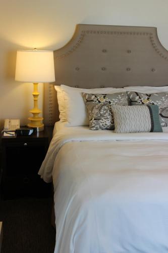 a bedroom with a white bed with a lamp and pillows at The Mark Spencer Hotel in Portland