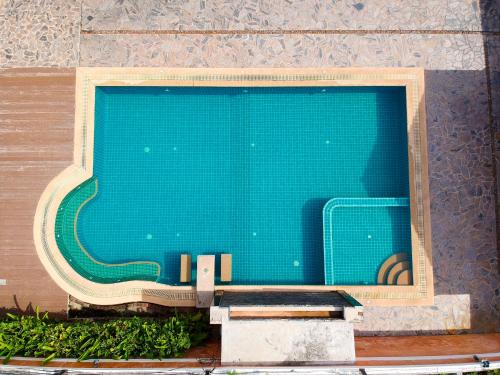 a close up of a swimming pool with a blue at Grandsmile Wellness Resort in Pattaya