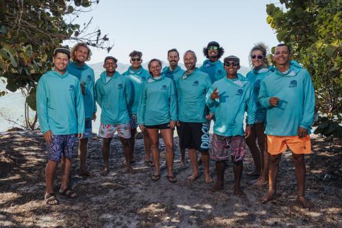 a group of men in blue shirts posing for a picture at Panama Kite Center in Punta Chame