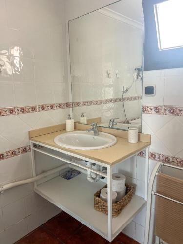 a bathroom with a sink and a large mirror at Casa Picón in Tinajo