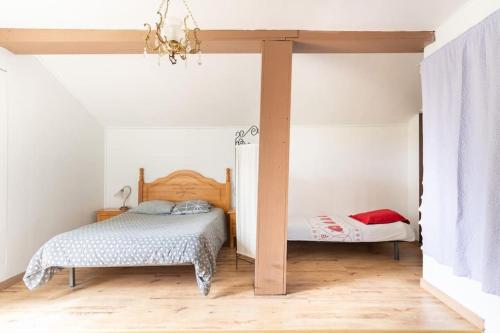 a bedroom with two beds in a room at Havre de paix idéal en famille in Monceaux