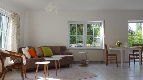 a living room with a couch and a table at Ferienwohnung Seelenbaumler in Flonheim