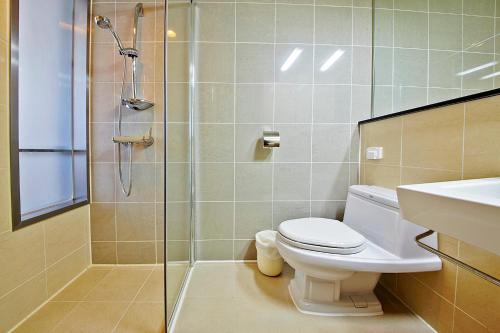 a bathroom with a shower and a toilet and a sink at High1 Condominium in Jeongseon