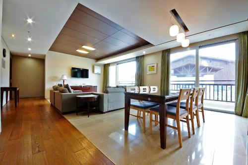 a living room with a table and chairs and a couch at High1 Condominium in Jeongseon