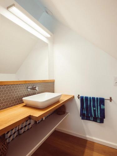 a bathroom with a sink and a mirror at Maison ORGO in Le Palais