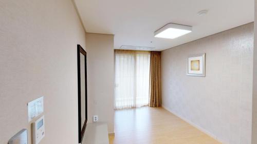 an empty room with a hallway with a window at High1 Condominium in Jeongseon
