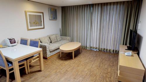 a living room with a couch and a table at High1 Condominium in Jeongseon