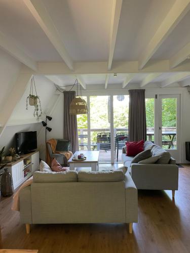 a living room with two couches and a table at La petite maison Durbuy in Durbuy