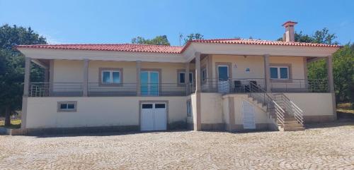 a house with a balcony on top of it at Lugar de Levides in Levide