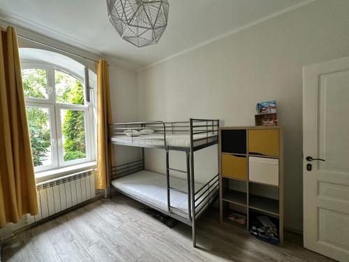 a bedroom with a bunk bed and a window at Mazurski klimat in Ełk