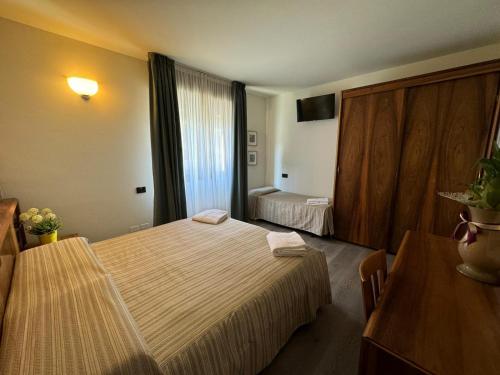 a hotel room with a large bed in a room at Continental Hotel in Lovere