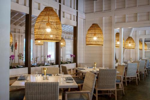 a dining room with tables and chairs and chandeliers at Hyatt Regency Coconut Point Resort & Spa Near Naples in Bonita Springs