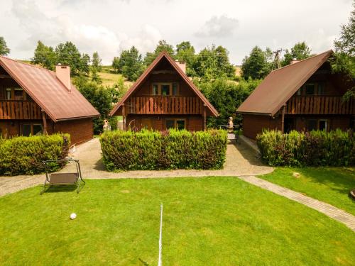 an image of a yard with two houses at Całoroczne Domki "Stokrotka" in Solina