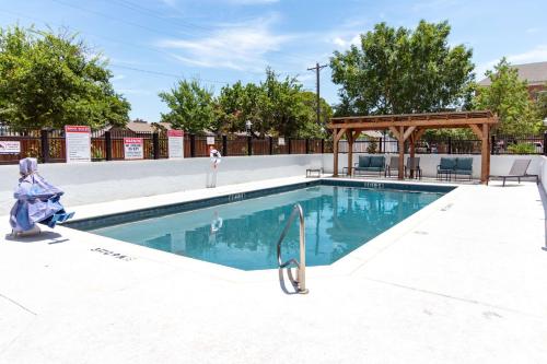 a swimming pool with a gazebo next to it at Hampton Inn & Suites Denton in Denton