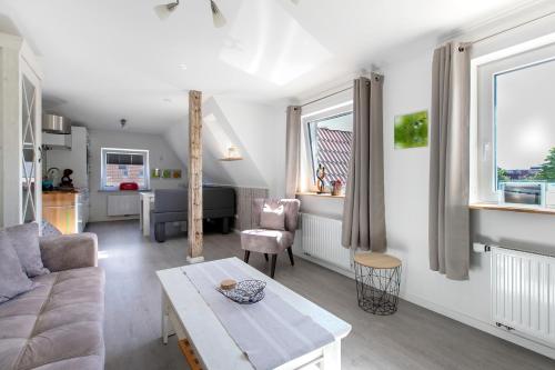 a living room with a couch and a table at Ferienwohnung Nordfriesland in Niebüll