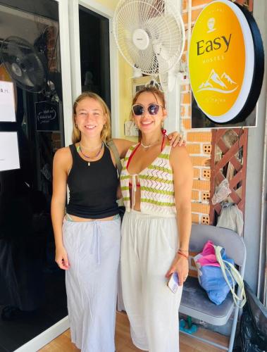 two women are standing next to each other at Easy Hostel in Phi Phi Don