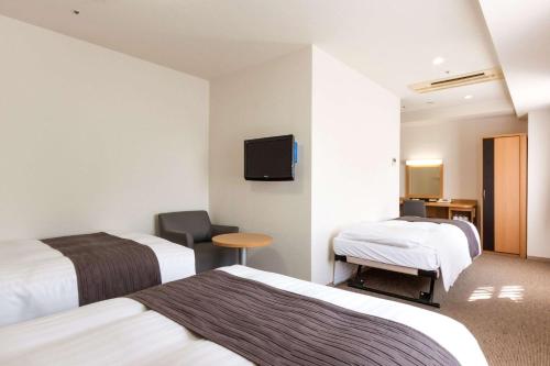 Postel nebo postele na pokoji v ubytování Comfort Hotel Yokohama Kannai