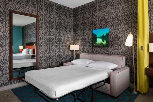 a bedroom with a bed and a mirror at Home2 Suites by Hilton Rochester Mayo Clinic Area in Rochester