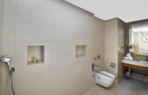 a bathroom with a toilet and a sink at Hilton Taghazout Bay Beach Resort & Spa in Taghazout